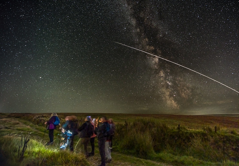 A photo of people looking at a starry sky