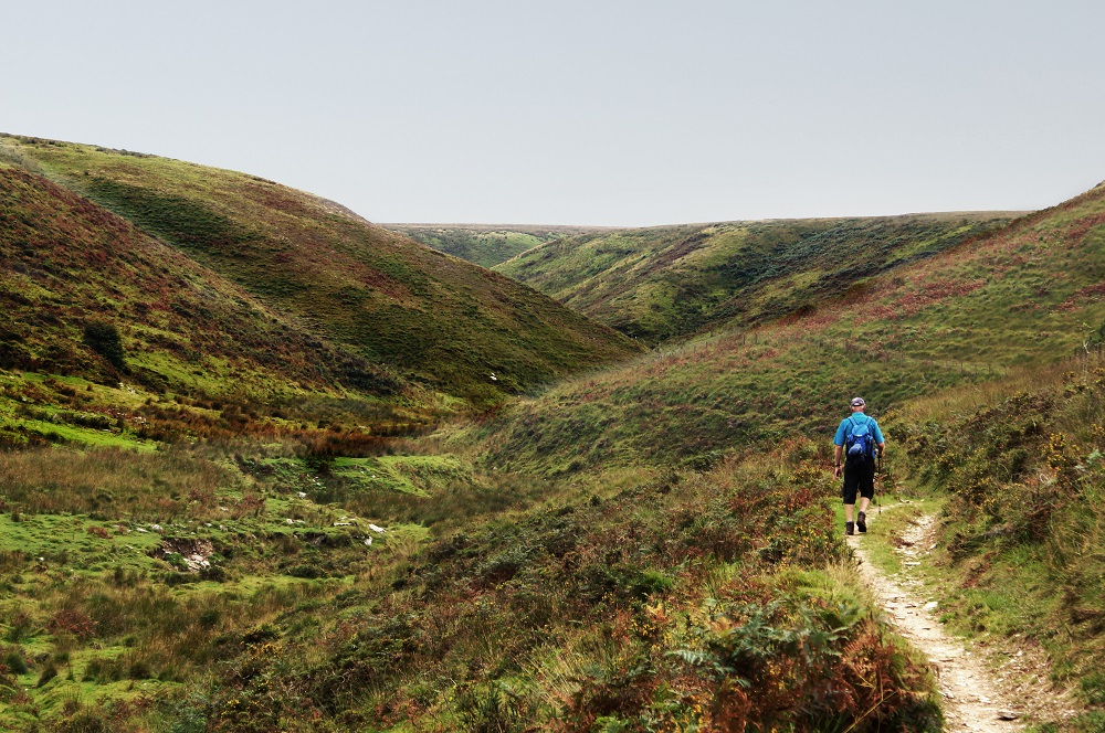 Walker on a footpath on the two Moors Way