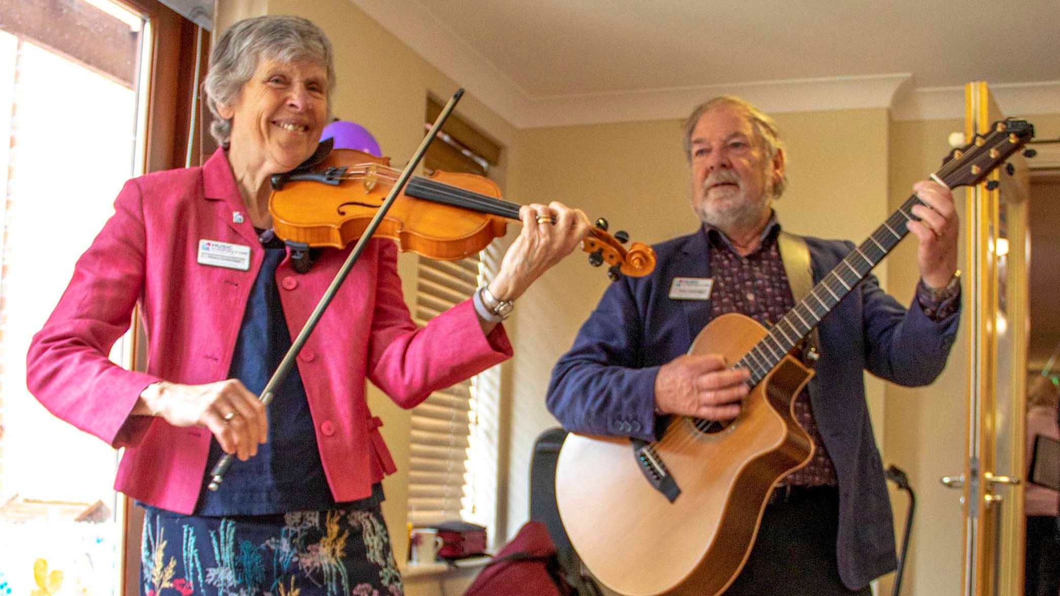 Photo of 2 people playing instruments